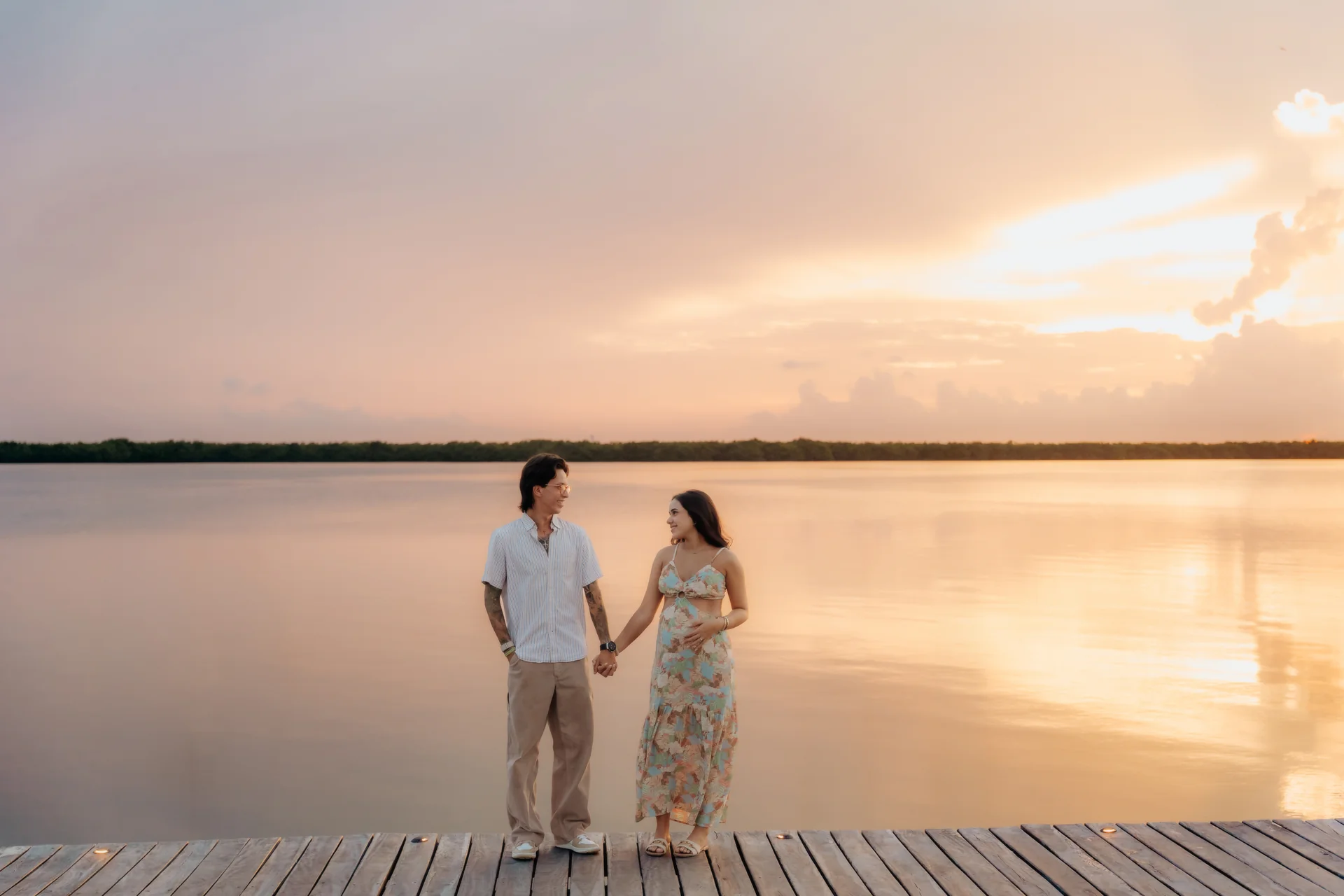 Newly engaged couple at the water's edge, Navios restaurant, Cancún