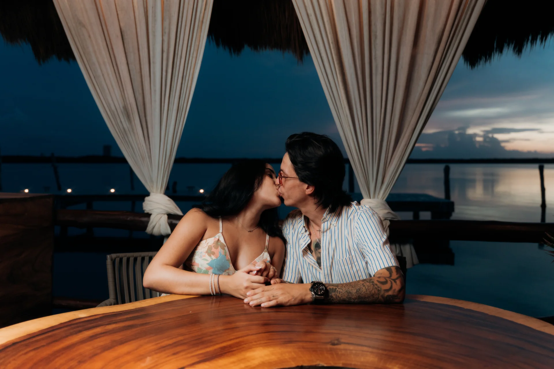Couple embracing with the water behind them, Navios restaurant, Cancún